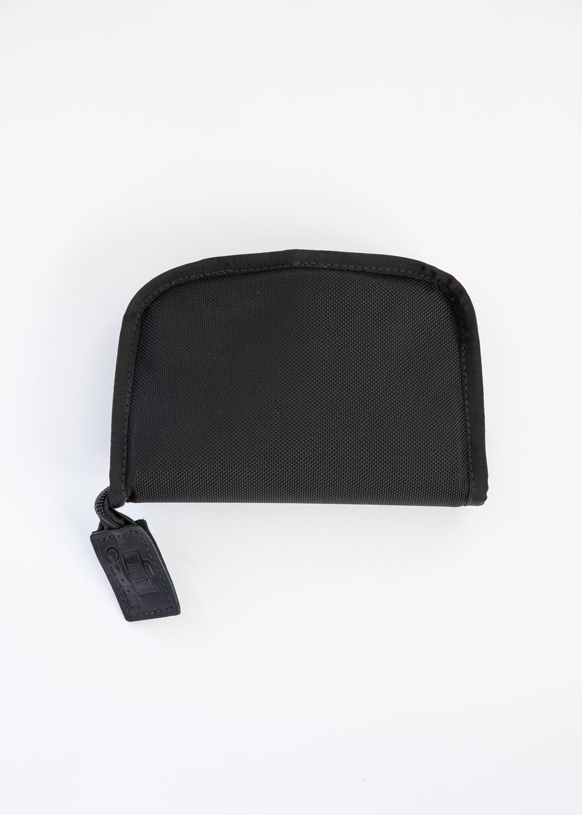 A black zippered pouch with a textured fabric exterior and a black zipper pull tab, photographed on a clean white background.